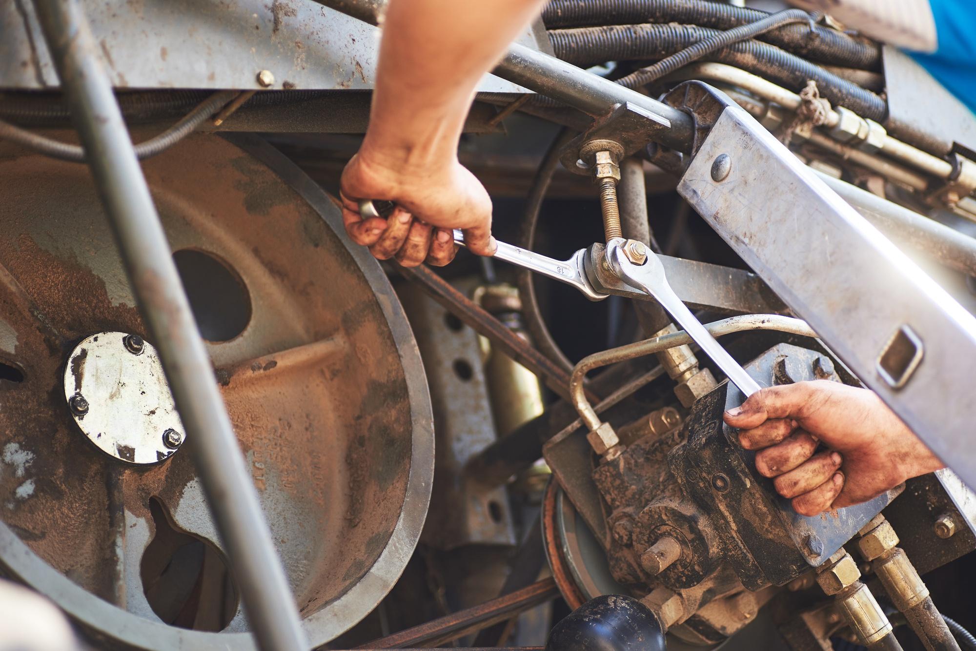 Mechanics using wrenches on industrial rotating machinery