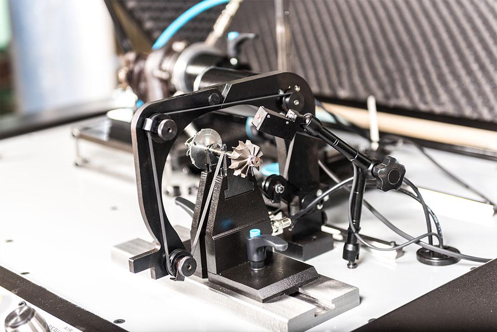 Turbocharger rotor undergoing precision dynamic balancing